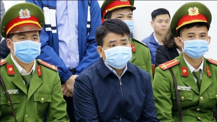 Cựu Chủ Tịch TP. Hà Nội Nguyễn Đức Chung (giữa) trước tòa trong các vụ án Nhật Cường, Arktic... với tội danh "lợi dụng chức vụ, quyền hạn trong khi thi hành công vụ." Ảnh: TTXVN